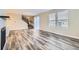 Open-concept living room featuring modern wood floors, large windows, and a staircase at 2356 W 165Th Pl, Broomfield, CO 80023