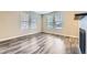 Light-filled living room with wood flooring, large windows, and a cozy atmosphere at 2356 W 165Th Pl, Broomfield, CO 80023