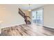 Open-concept living area with wood floors, a staircase, and a sliding glass door at 2356 W 165Th Pl, Broomfield, CO 80023