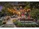 Inviting backyard with string lights, comfortable seating, and lush landscaping at 8691 Bluebunch Ct, Parker, CO 80134