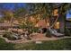 Inviting backyard with string lights, patio seating, stone pavers, and lush landscaping for outdoor enjoyment at 8691 Bluebunch Ct, Parker, CO 80134