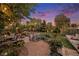 Relaxing backyard with string lights, fire pit, cozy seating, and garden beds at 8691 Bluebunch Ct, Parker, CO 80134