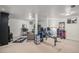 Spacious basement featuring gym equipment, a TV, and bedroom area at 8691 Bluebunch Ct, Parker, CO 80134