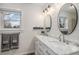 Bright bathroom features a double sink vanity with marble countertop and modern lighting fixtures at 8691 Bluebunch Ct, Parker, CO 80134