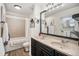 Bathroom with a double vanity, large mirror, and a shower/tub combo at 8691 Bluebunch Ct, Parker, CO 80134
