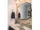 Stylish bathroom features stone accent wall, modern mirror, and silver faucet at 8691 Bluebunch Ct, Parker, CO 80134
