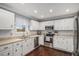 Kitchen features stainless steel appliances, white cabinets, and a view from the window over the sink at 8691 Bluebunch Ct, Parker, CO 80134