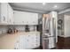 Bright kitchen features white cabinets, stainless steel appliances, and lots of counter space at 8691 Bluebunch Ct, Parker, CO 80134