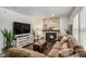 Cozy living room featuring a stone fireplace, plush seating, and hardwood floors at 8691 Bluebunch Ct, Parker, CO 80134