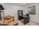 Office features leather chairs, a modern desk and a window at 8691 Bluebunch Ct, Parker, CO 80134