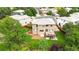 Aerial view of the backyard featuring a deck, patio with hot tub, and lush landscaping at 9169 Fox Fire Way, Highlands Ranch, CO 80129