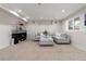 Cozy finished basement featuring neutral tones, plush carpeting, and comfortable seating at 9169 Fox Fire Way, Highlands Ranch, CO 80129