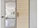 Stylish barn door leading into a bright bathroom with double vanities and a soaking tub at 9169 Fox Fire Way, Highlands Ranch, CO 80129
