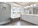 Luxurious bathroom featuring a glass-enclosed shower, soaking tub, dual sinks, and natural light at 9169 Fox Fire Way, Highlands Ranch, CO 80129