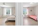 Split shot of two bedrooms, each with light hardwood floors, neutral walls, and bright, natural light at 9169 Fox Fire Way, Highlands Ranch, CO 80129