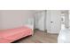 Charming bedroom featuring a pink quilt, built-in closet, light wood floors, and lots of natural light at 9169 Fox Fire Way, Highlands Ranch, CO 80129
