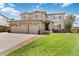 Charming two-story home featuring a well-kept lawn, two-car garage and inviting front porch at 9169 Fox Fire Way, Highlands Ranch, CO 80129
