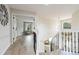 Elegant hallway featuring hardwood floors, decorative wrought iron stair railings, and modern lighting at 9169 Fox Fire Way, Highlands Ranch, CO 80129