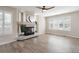 Bright living room featuring hardwood floors, fireplace, large windows and a ceiling fan at 9169 Fox Fire Way, Highlands Ranch, CO 80129