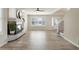 Bright living room with hardwood floors, a fireplace, and modern front door at 9169 Fox Fire Way, Highlands Ranch, CO 80129