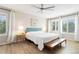 Inviting bedroom featuring plantation shutters, hardwood floors, and a cozy seating area at 9169 Fox Fire Way, Highlands Ranch, CO 80129