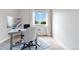 Bright office space featuring a modern desk, sleek computer, and large window with mountain views at 9169 Fox Fire Way, Highlands Ranch, CO 80129