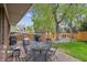 Back deck area featuring a table and chair set, a grill, and surrounding landscape at 12752 W Asbury Pl, Lakewood, CO 80228