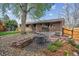 Backyard patio featuring a table and chair set surrounded by landscaping at 12752 W Asbury Pl, Lakewood, CO 80228