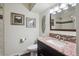 Updated bathroom with granite countertop, mosaic tile backsplash, and framed artwork at 12752 W Asbury Pl, Lakewood, CO 80228