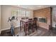 Cozy dining area with hardwood floors, a fireplace, and a dining table set for four at 12752 W Asbury Pl, Lakewood, CO 80228