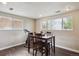 Bright dining area with hardwood floors, a dining table set for four, and great natural light at 12752 W Asbury Pl, Lakewood, CO 80228