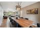 Open concept dining room with wood table, stone fireplace and living room in background at 12752 W Asbury Pl, Lakewood, CO 80228