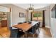 Dining room featuring a wood table with seating for eight, contemporary lighting, and a window at 12752 W Asbury Pl, Lakewood, CO 80228