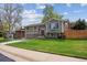 Attractive home featuring a well-maintained front yard, appealing landscaping, and inviting curb appeal on a sunny day at 12752 W Asbury Pl, Lakewood, CO 80228