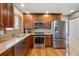Modern kitchen featuring stainless steel appliances, granite countertops, and ample cabinetry at 12752 W Asbury Pl, Lakewood, CO 80228