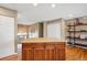 Kitchen island featuring hardwood floors, granite countertops, and ample storage at 12752 W Asbury Pl, Lakewood, CO 80228