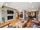 Spacious living room with stone fireplace, hardwood floors, and an open layout at 12752 W Asbury Pl, Lakewood, CO 80228