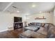 Inviting living room featuring a comfortable leather sectional, dark hardwood floors, and recessed lighting at 12752 W Asbury Pl, Lakewood, CO 80228