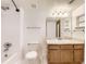 A well-lit bathroom includes a tub with shower, toilet, and vanity with wood cabinets, creating a functional space at 1351 S Cathay Ct # 102, Aurora, CO 80017