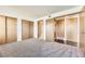 Spacious bedroom with multiple closets and doorways to the bathroom and hall at 1351 S Cathay Ct # 102, Aurora, CO 80017