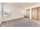 Bright bedroom with large windows and closet space, offering natural light and a serene atmosphere at 1351 S Cathay Ct # 102, Aurora, CO 80017