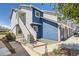 Charming multi-level home featuring blue and white siding, inviting front entrances with stairs, and low-maintenance landscaping at 1351 S Cathay Ct # 102, Aurora, CO 80017