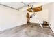 Empty garage with concrete floor, white walls, overhead door, and a ladder at 1351 S Cathay Ct # 102, Aurora, CO 80017