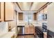 Functional kitchen with stainless steel dishwasher, microwave, and a large window with natural light at 1351 S Cathay Ct # 102, Aurora, CO 80017