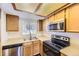 Fully equipped kitchen with stainless steel appliances and functional layout at 1351 S Cathay Ct # 102, Aurora, CO 80017