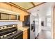 Well-appointed kitchen with a refrigerator, microwave, oven, and a view to the living room fireplace at 1351 S Cathay Ct # 102, Aurora, CO 80017