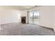 Bright living room with plush carpeting, a brick fireplace, and a sliding glass door offering access to the outdoor balcony at 1351 S Cathay Ct # 102, Aurora, CO 80017