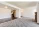A spacious living room featuring wood and carpet flooring, neutral paint and open access to other rooms of the home at 1351 S Cathay Ct # 102, Aurora, CO 80017