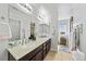 Bright bathroom with a double vanity, decorative mirrors, and tiled floors at 12972 Uinta Ct, Thornton, CO 80602