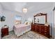 Cozy bedroom with large windows, soft rug and decorative details at 12972 Uinta Ct, Thornton, CO 80602